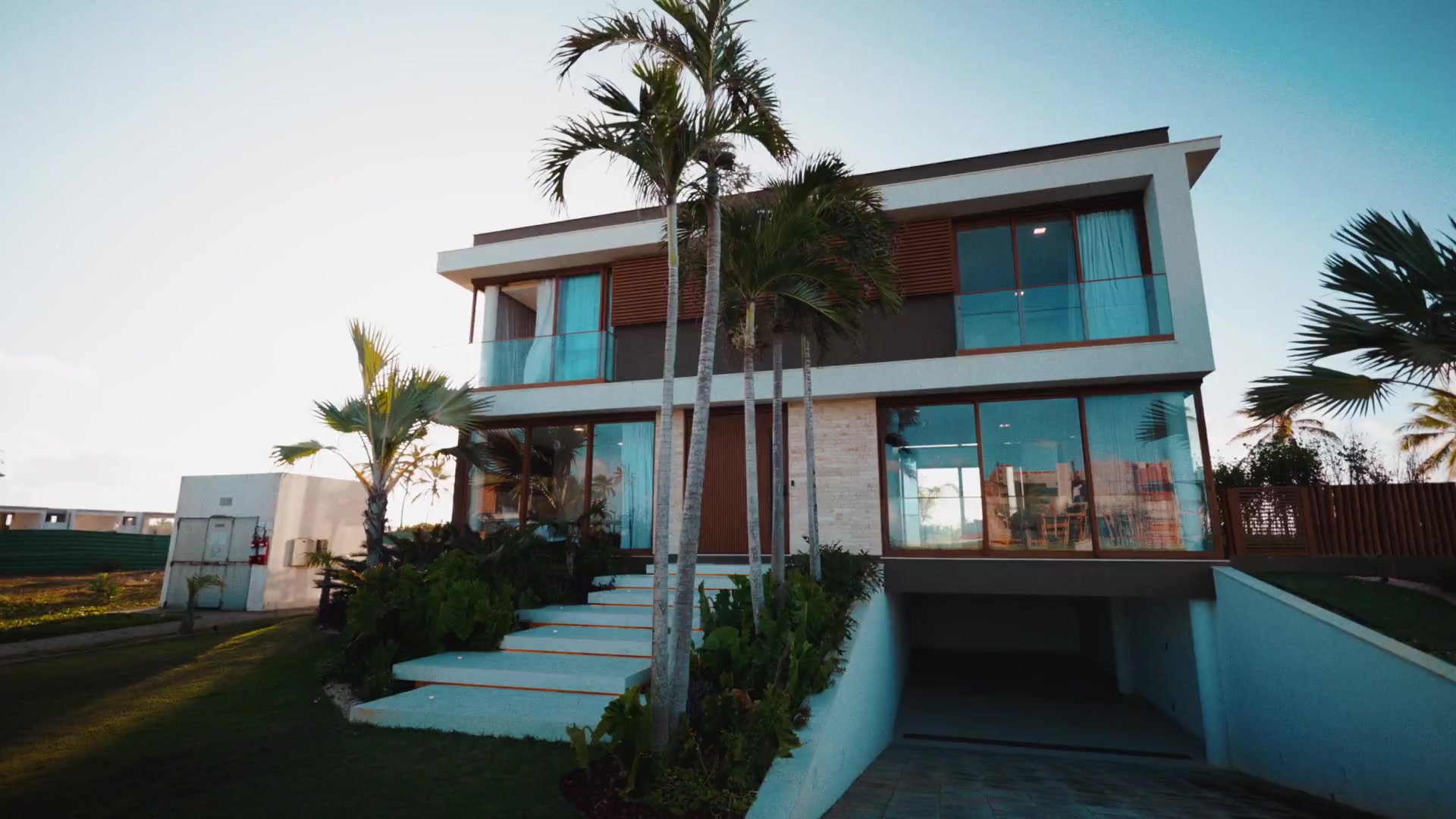 AVÉRA private villa framed by palms, with pale stone and warm timber